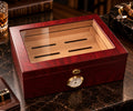 Cedar box with red woodgrain finish, glass viewing lid, wooden interior, and front dial
